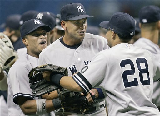 Robinson Cano, Alex Rodriguez, and Melky Cabrera celebrate after the team clinched a playoff berth.